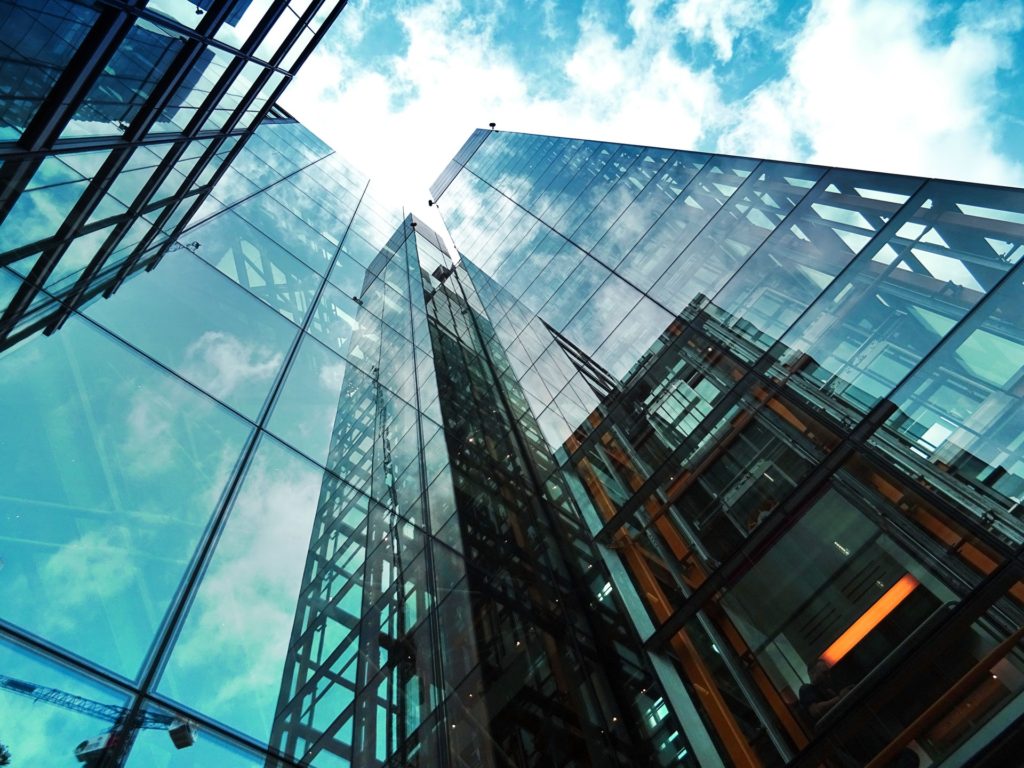 Skyscrapers with turquoise sky and reflections in glass